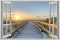 Naklejka do salonu WIDOK PRZEZ OKNO BIAŁE zachód słońca nad morzem pomost